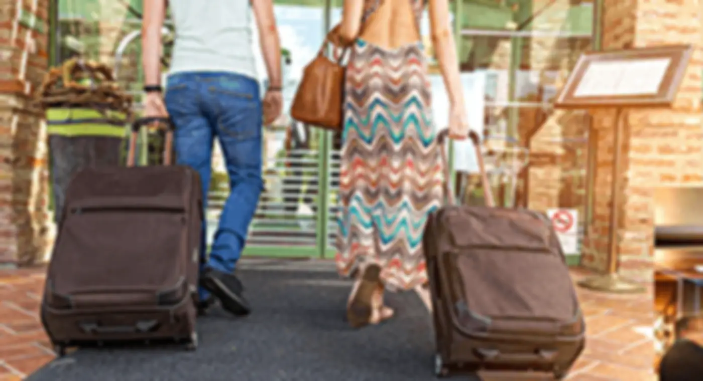 Guests arriving at a hotel with their luggage